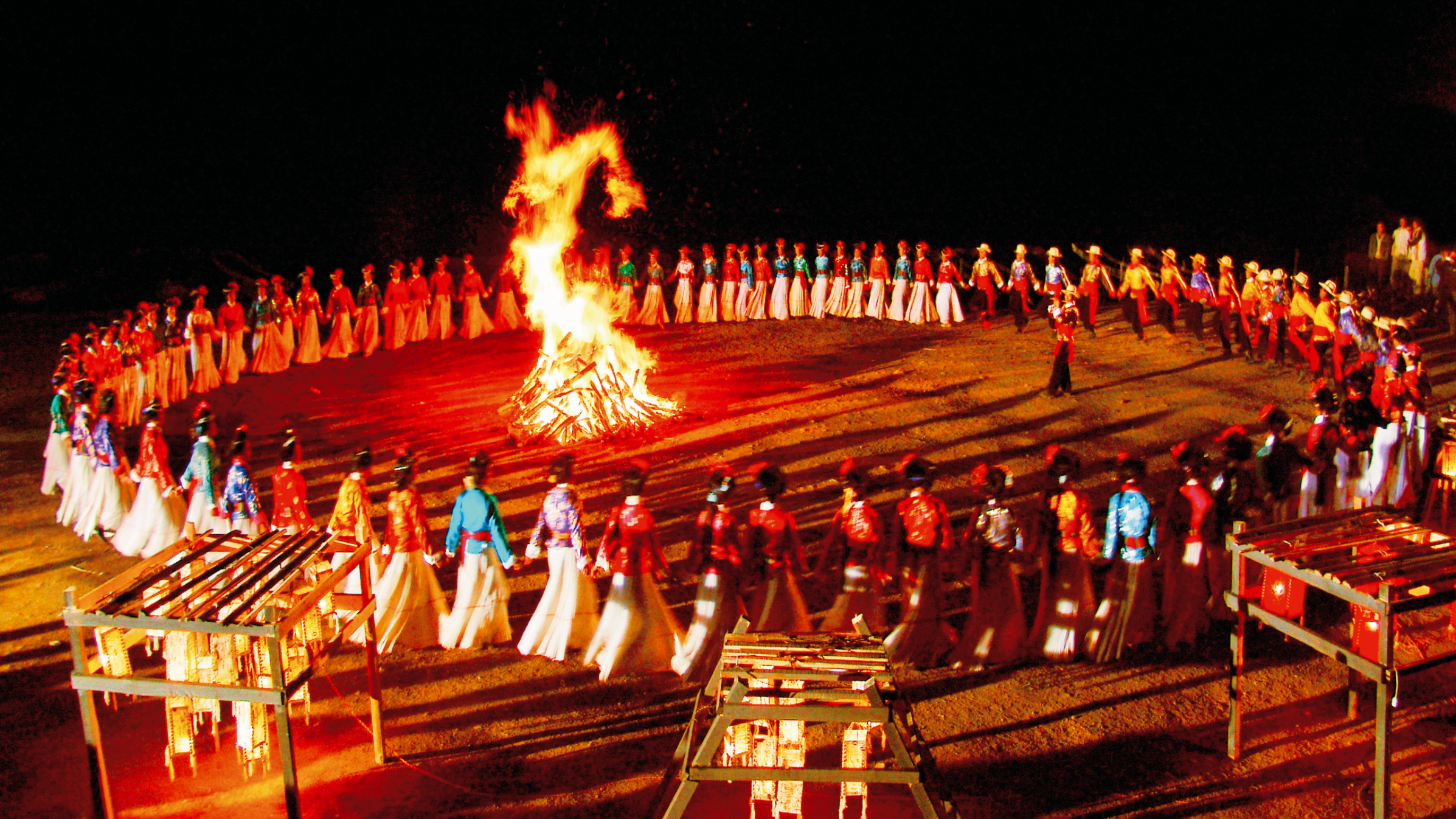 Mosuo people dance around bonfire in southwest China's Yunnan Province in this undated photo. /Photo provided to CGTN