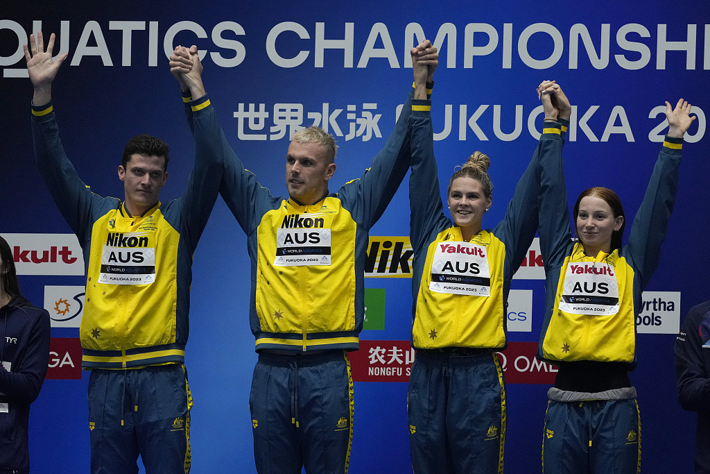 Swimmers of Team Australia celebrate on the podium after winning the mixed 4X100m freestyle relay final during the World Aquatics Championships in Fukuoka, Japan, July 29, 2023. /CFP