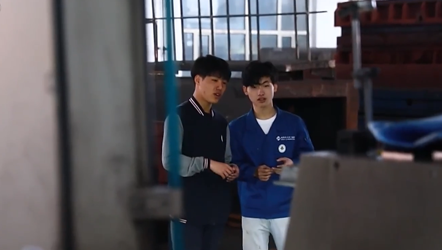 Wang Qi (R) and his brother Wang Tao in Genertec Qiqihar No. 2 Machine Tool Factory, Qiqihar, northeast China's Heilongjiang Province, July, 2023. /CMG