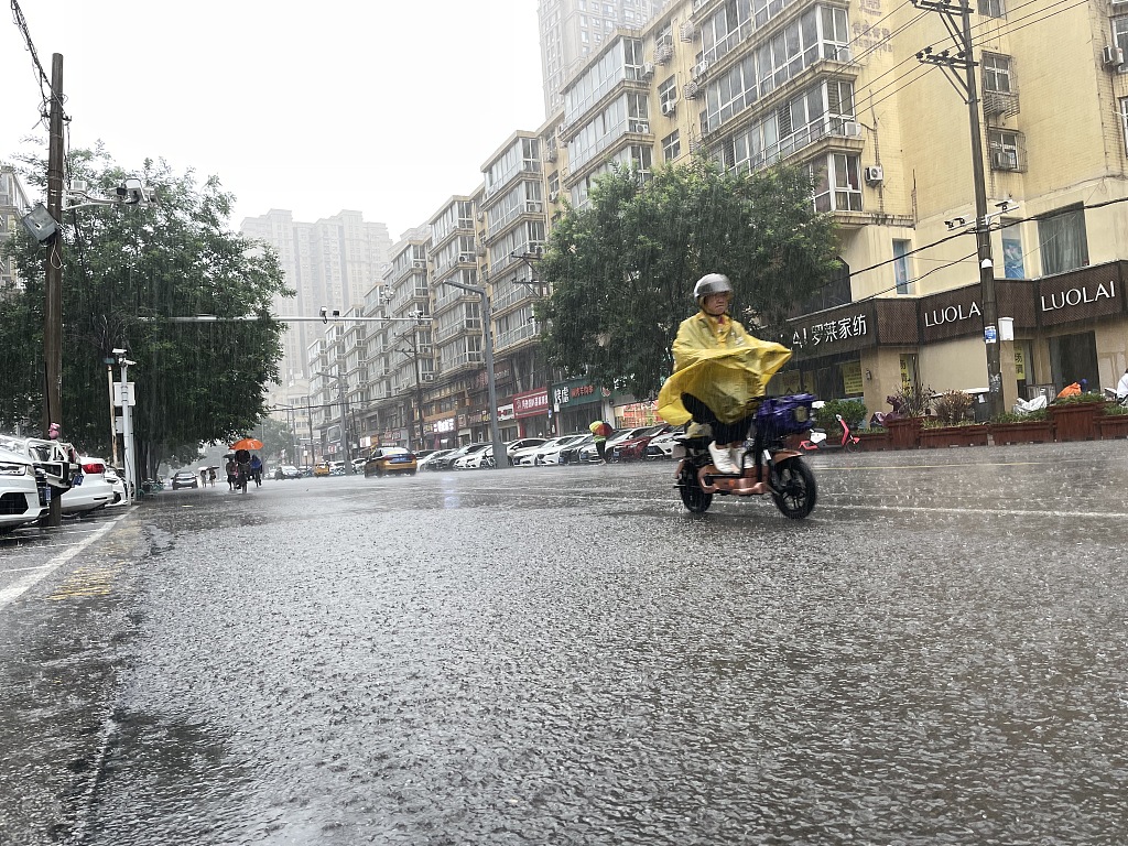 A rider in the rain in Shijiazhuang, Hebei Province, July 30, 2023. /CFP