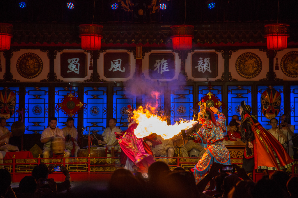 The dazzling face-changing and fire-spitting techniques are among the most fascinating stunts and most distinctive charms of Sichuan Opera, one of the oldest forms of Chinese opera. This photo taken on September 12, 2017 shows a Sichuan opera actor amazing viewers with an eye-catching fire-spitting performance in Chengdu, Sichuan Province. /CFP