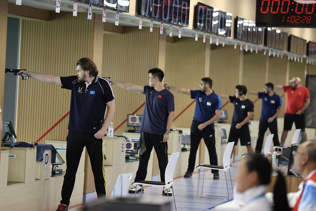 Athletes in action during the competition of sport shooting in the 25m rapid fire pistol team men's final at the World University Games in Chengdu, China, July 30, 2023. /CFP