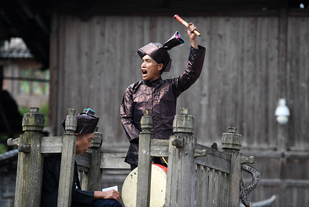 A priest leads the villagers to shout to the sky during the han tian jie festival at Huanggang Village, Liping County, southwest China's Guizhou Province, on July 13, 2022. /CFP 