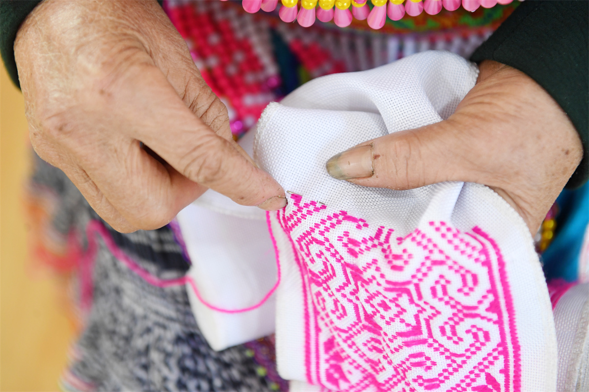 Miao women make embroidery products at a studio at Longgang Village, Huairen City, southwest China's Guizhou Province, March 14, 2023. /CNSPHOTO
