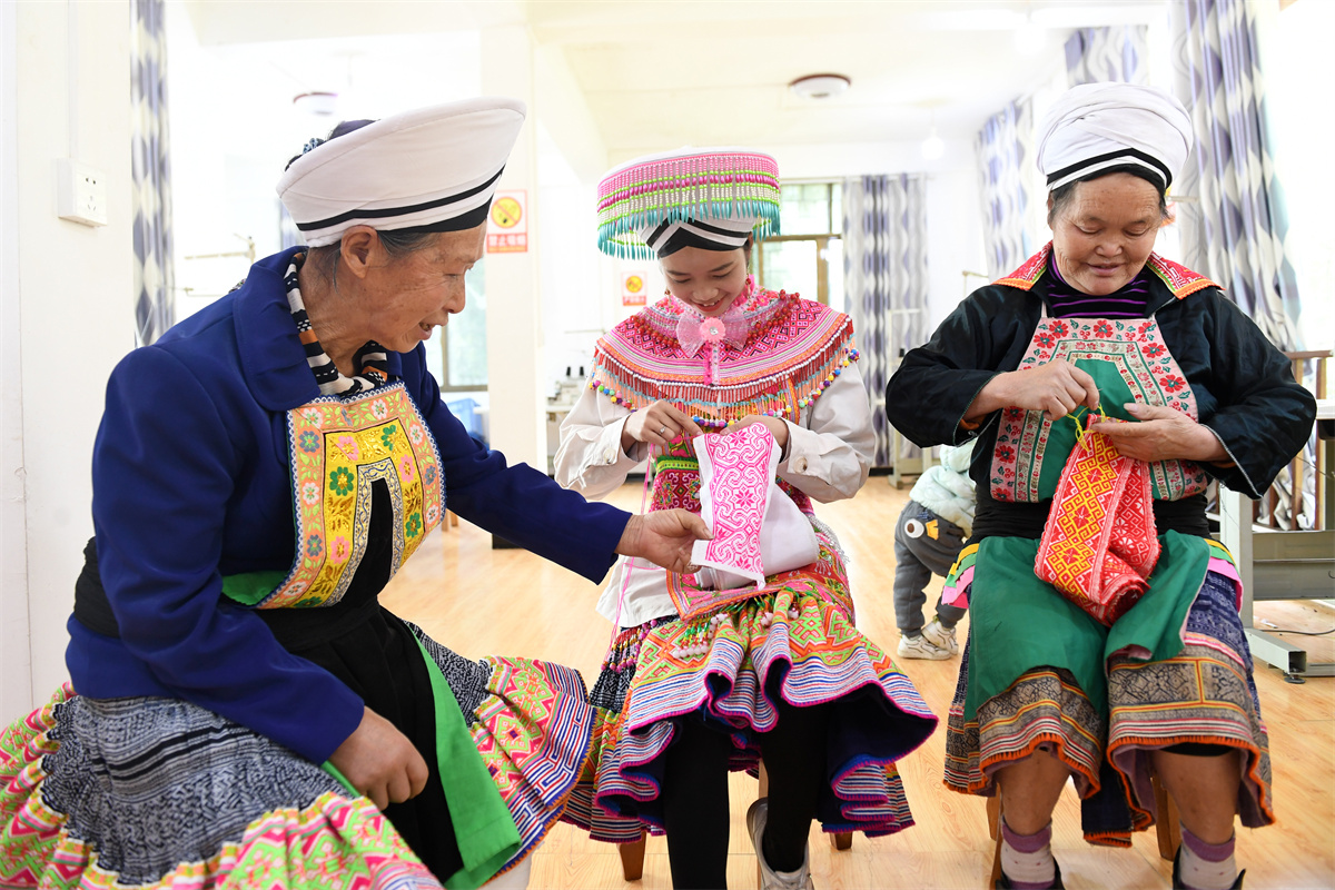 Miao women make embroidery products at a studio at Longgang Village, Huairen City, southwest China's Guizhou Province, March 14, 2023. /CNSPHOTO