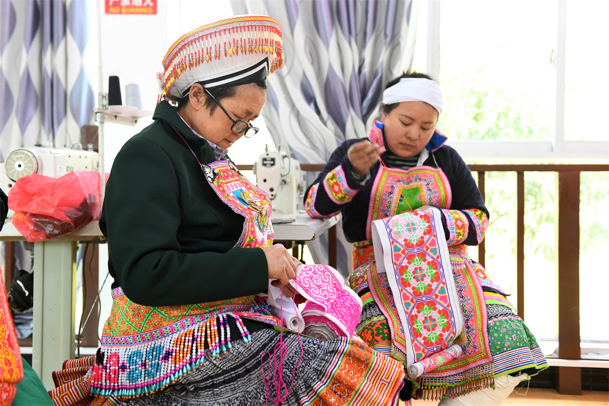 Miao women make embroidery products at a studio at Longgang Village, Huairen City, southwest China's Guizhou Province, March 14, 2023. /CNSPHOTO