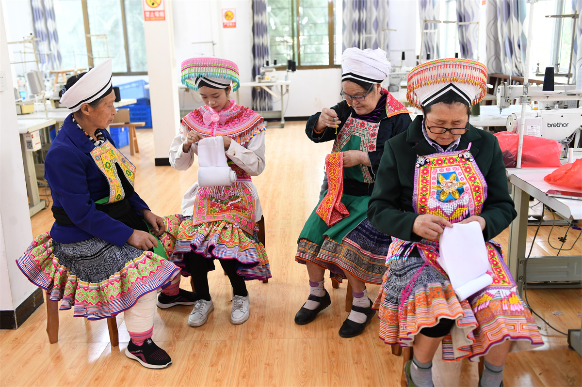 Miao women make embroidery products at a studio at Longgang Village, Huairen City, southwest China's Guizhou Province, March 14, 2023. /CNSPHOTO