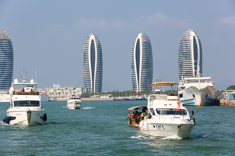 Visitors take a yacht tour at the Hongzhou Wharf Tourism and Leisure Block in Sanya City, Hainan Province. /CFP