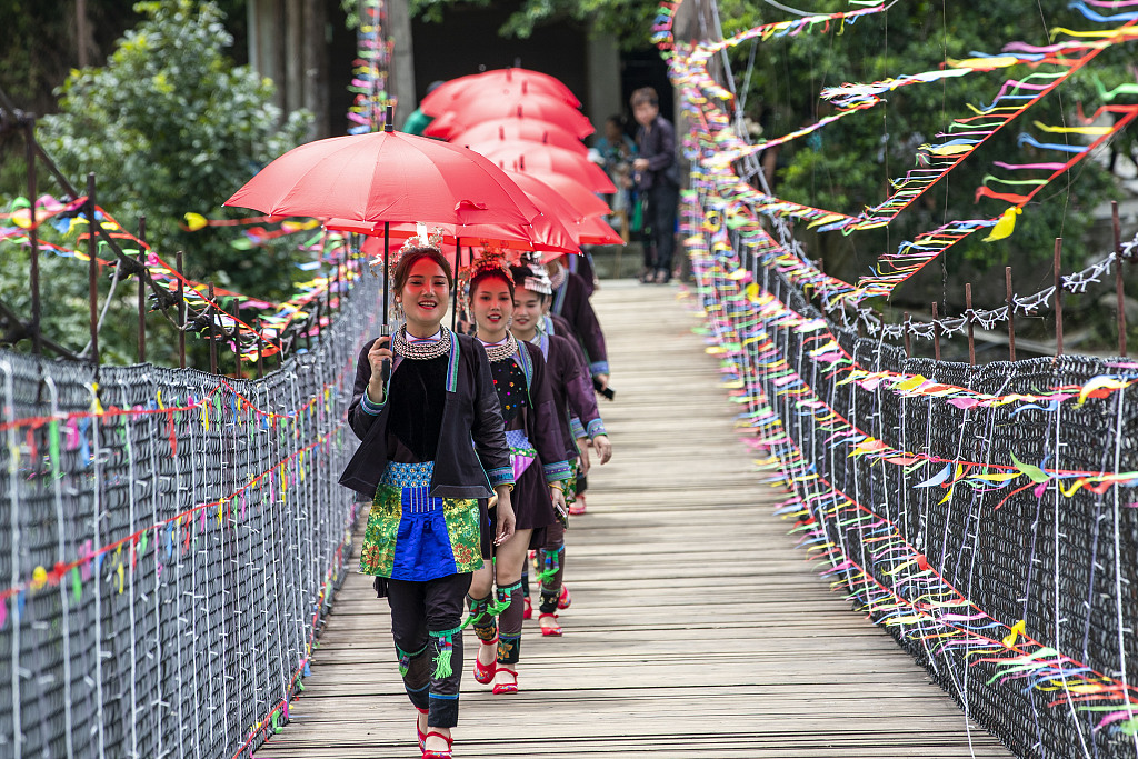 This photo, taken on July 31, 2023, shows young women from the Zhuang ethnic group joining the Diving Festival in Gangbian Village, Congjiang County, Guizhou Province, China. /CFP