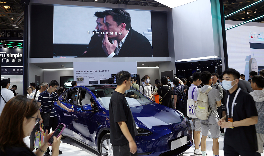 Tourists visit the booth of Tesla at the 2023 World Artificial Intelligence Conference in Shanghai, east China, July 6, 2023. /CFP