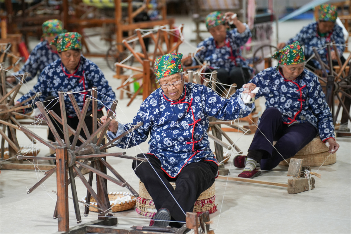 Women are busy doubling thread at a factory in Dongkaizhang Village, Yongji City, north China's Shanxi Province on May 18, 2023. /CNSPHOTO