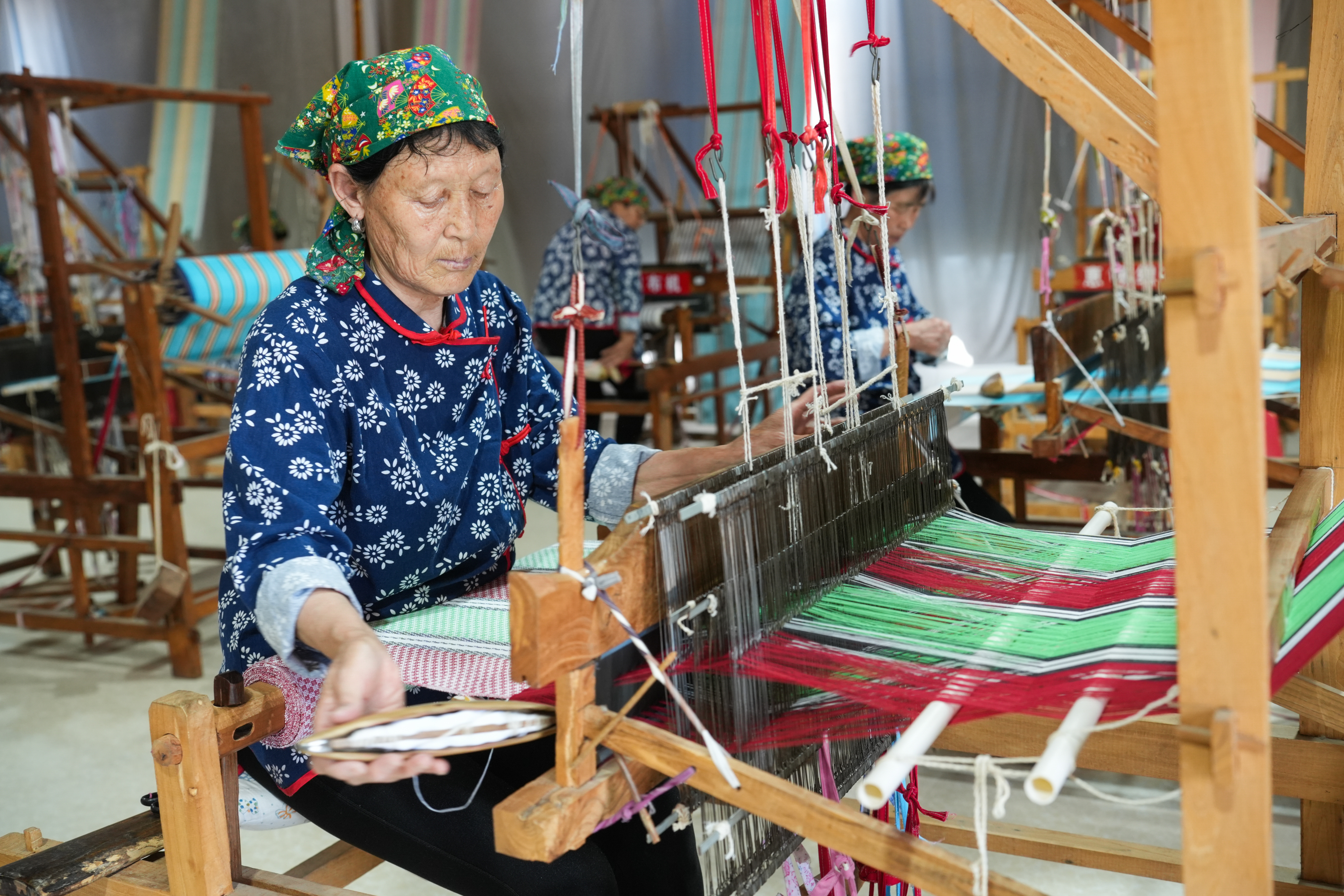Women are busy weaving Huichang cloth at a factory in Dongkaizhang Village, Yongji City, north China's Shanxi Province on May 18, 2023. /CNSPHOTO
