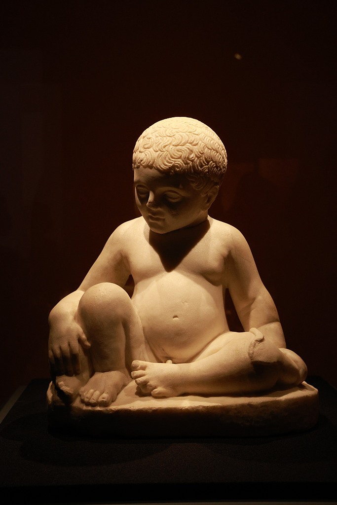 A marble sculpture of a boy is on display at an exhibition on ancient Roman culture at the Nanshan Museum in Shenzhen, south China's Guangdong Province, August 2, 2023. /CFP
