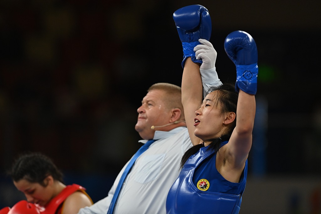 China's Li Zhiqin has her hand raised in victory after winning the women's 60kg final of Sanda at the World University Games in Chengdu, Sichuan Province, China, August 3 2023. /CFP