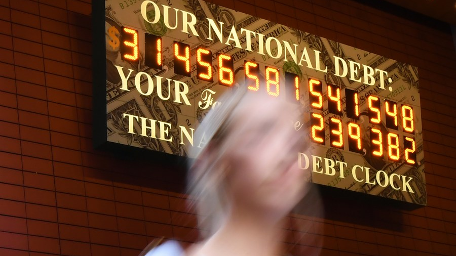 A woman walks past the National Debt Clock in New York, the United States, June 1, 2023. /Xinhua