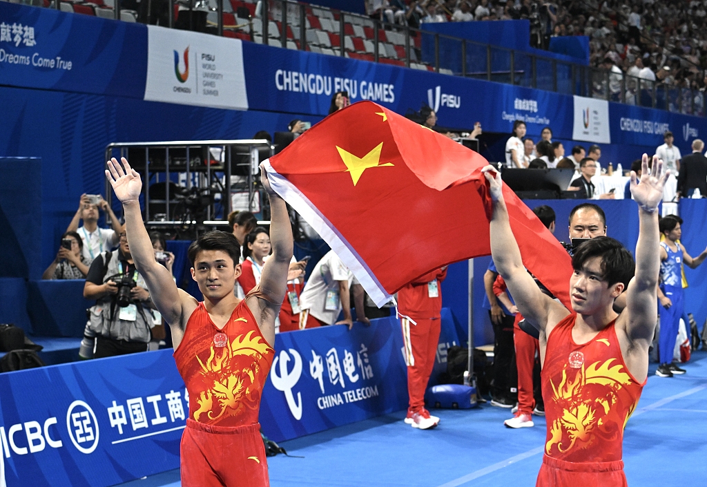 Zhang Boheng (R) and Shi Cong of China celebrate after taking the gold and silver medals in the artistic gymnastics men's individual all-around final at the World University Games in Chengdu, China, August 4, 2023. /CFP