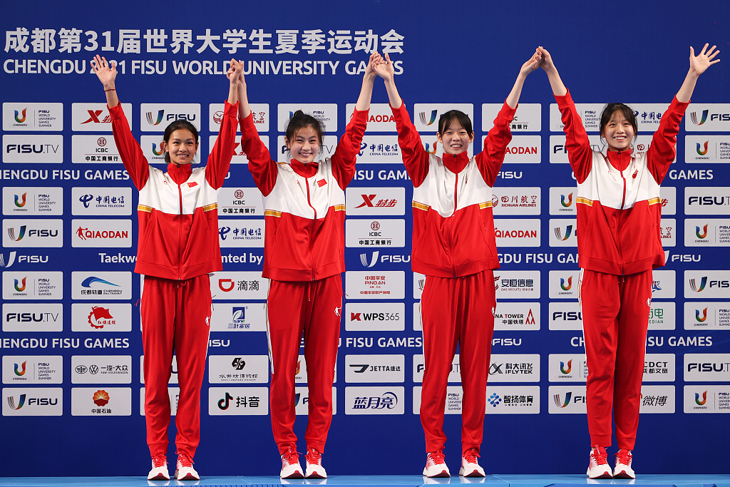 L-R: China's Yang Junli, Liu Junhong, Song Jie, and Zhou Qize celebrate on the podium after defeating Team Uzbekistan to win the taekwondo women's team title at the World University Games in Chengdu, China, August 4, 2023. /CFP