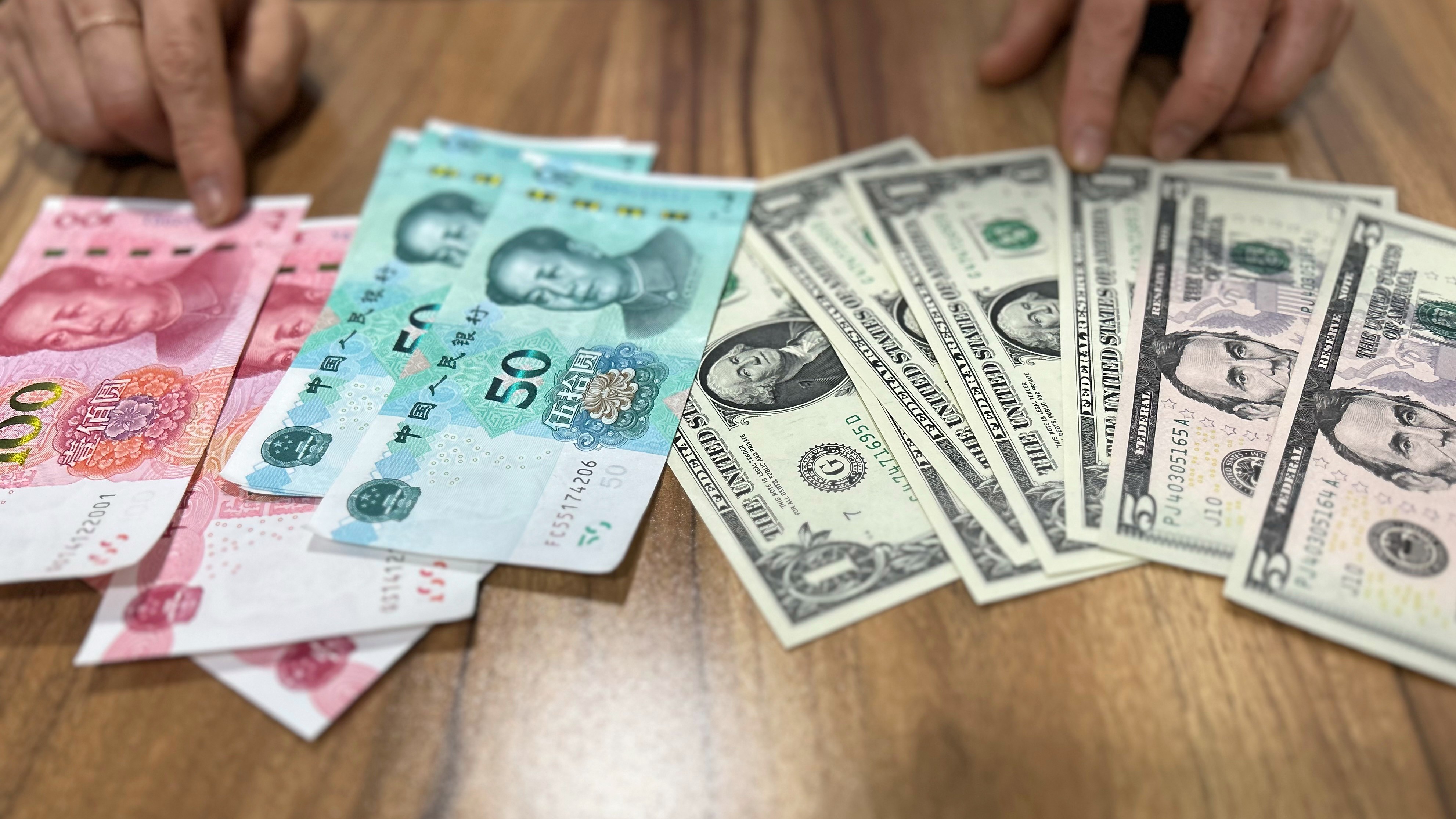 The bank notes of Chinese yuan and U.S. dollar, May 3, 2023. /AP