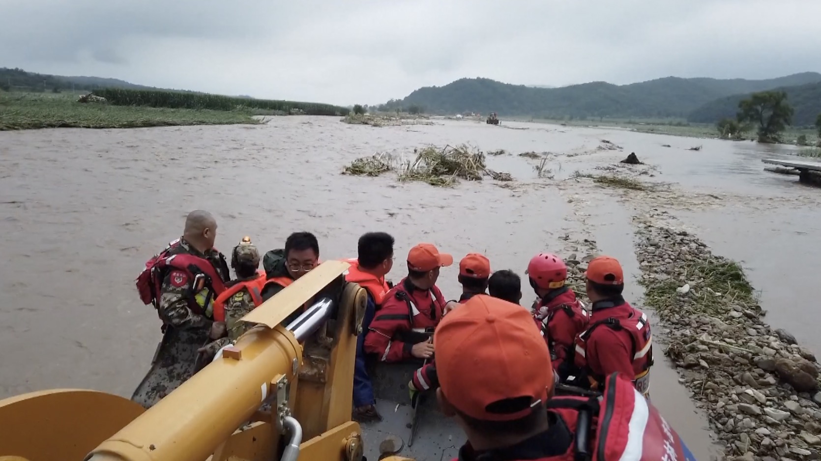 Evacuated villagers on an excavator. /CGTN