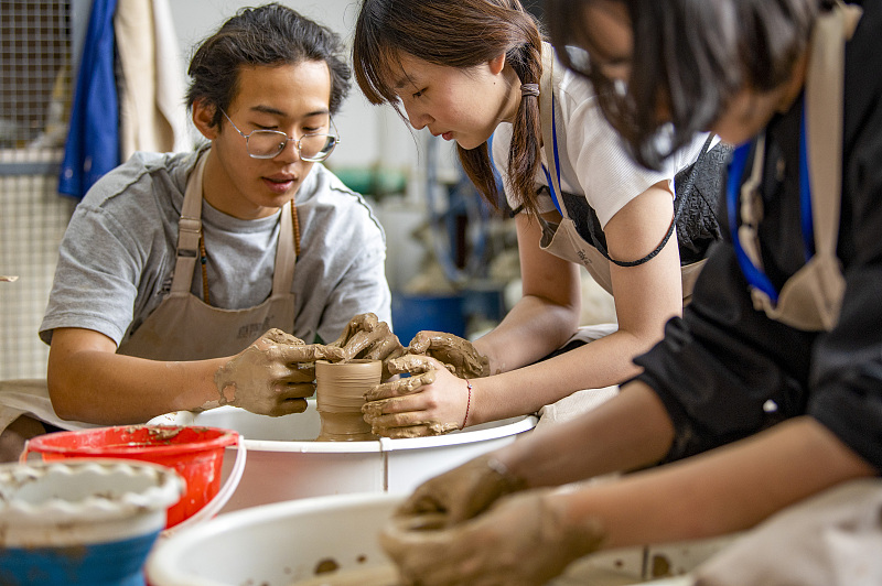 Students learn about ceramic crafts at Jinhua Polytechnic, in Zhejiang Province, July 5, 2023. /CFP