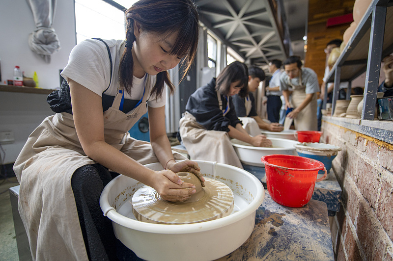 Students learn about ceramic crafts at Jinhua Polytechnic, in Zhejiang Province, July 5, 2023. /CFP