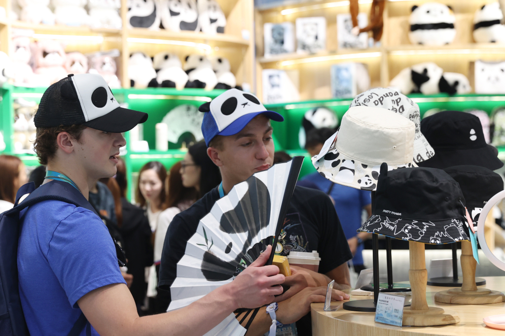 International participants of the 31st summer edition of the FISU World University Games select panda-themed souvenirs at the Chengdu Research Base of Giant Panda Breeding in southwest China's Sichuan Province, August 6, 2023. /CFP