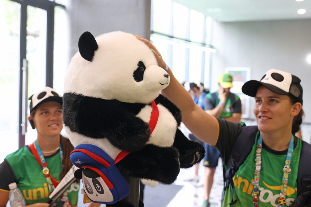 International participants of the 31st summer edition of the FISU World University Games select panda-themed souvenirs at the Chengdu Research Base of Giant Panda Breeding in southwest China's Sichuan Province, August 6, 2023. /CFP