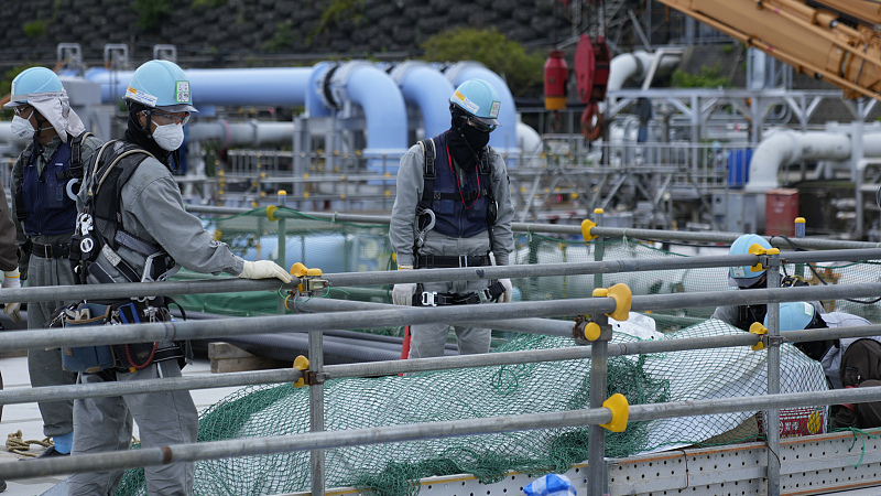 Workers put construction materials away before their lunch break at the Fukushima Daiichi nuclear power plant, operated by Tokyo Electric Power Company Holdings, in Futaba town, northeastern Japan, July 14, 2023. /CFP