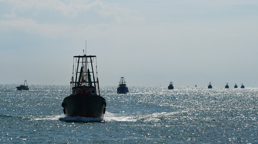 Fishing boats sail across the Qiongzhou Strait as the summer fishing moratorium ended in the South China Sea, August 16, 2021. /Xinhua