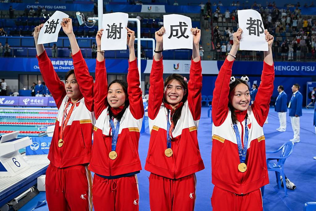 L-R: Liu Yaxin, Zhu Leiju, Zhang Yufei and Li Bingjie hold up papers saying 