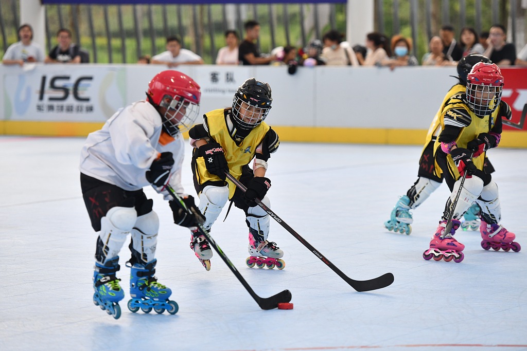 Children play roller hockey, which means playing ice hockey while wearing roller skates, in Chengdu, China, June 22, 2022. /CFP 