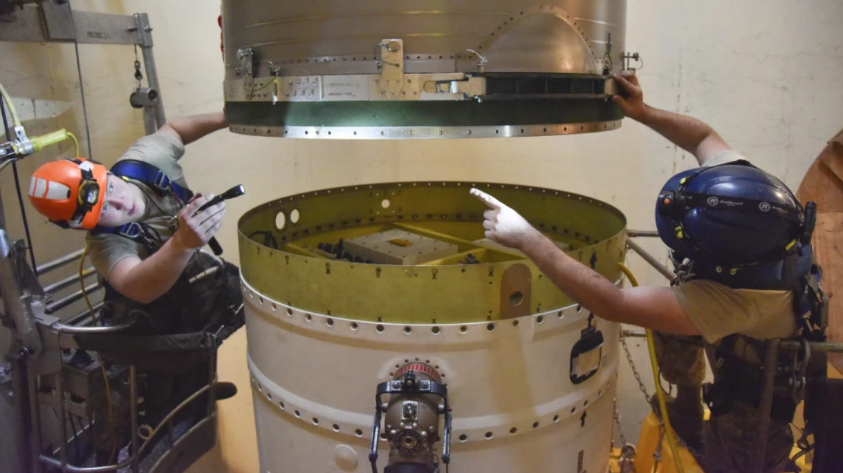 In this image provided by the U.S. Air Force, Airman 1st Class Jackson Ligon, left, and Senior Airman Jonathan Marinaccio, 341st Missile Maintenance Squadron technicians, connect a re-entry system to a spacer on an intercontinental ballistic missile during a Simulated Electronic Launch-Minuteman test, September 22, 2020, at a launch facility near Malmstrom Air Force Base in Great Falls, Montana, U.S. /AP