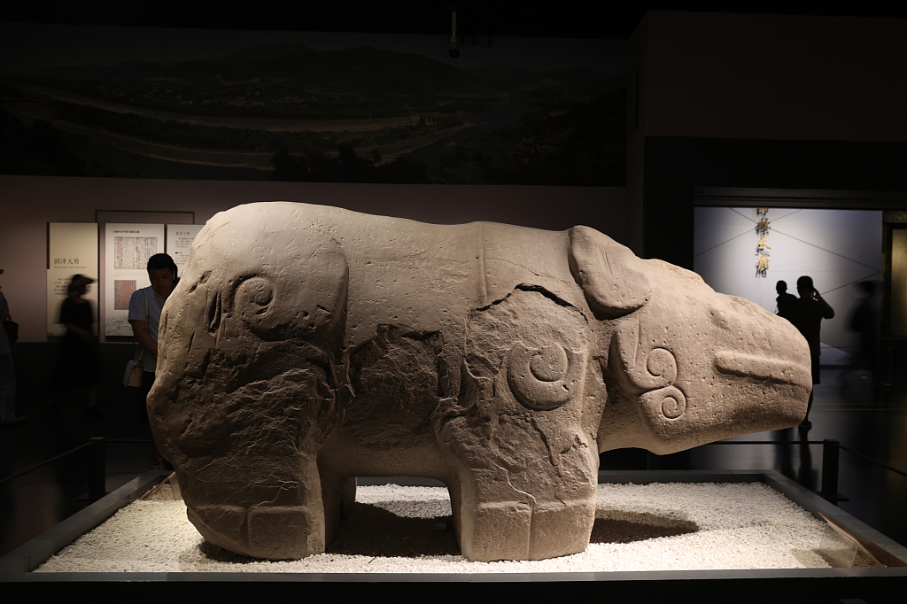 Visitors view a stone rhino at the Chengdu Museum in Sichuan Province on August 7, 2023. /CFP