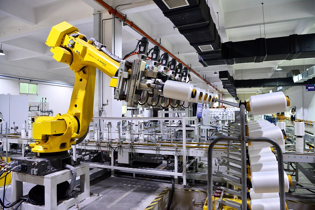 Robot arm operates in a textile plant in southeast China's Fujian Province, May 31, 2023. /CFP
