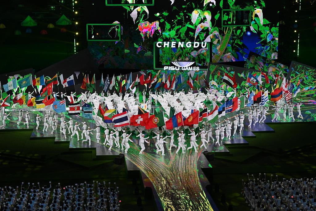 Performers hold up the flags of the 113 countries and regions that attended the 31st FISU Summer World University Games at the closing ceremony at the Chengdu Open Air Music Park, Sichuan Province, on August 8, 2023. /CFP