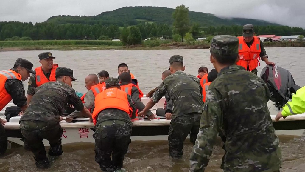 Chinese soldiers evacuate residents by boat in flood-affected area in Mudanjiang, northeast China's Heilongjiang Province, August 7, 2023. /CFP