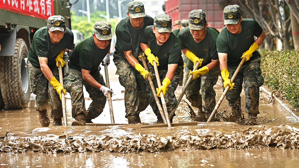 Soldiers clean mud, floodwater in Zhuozhou City, Hebei Province, China on August 6, 2023.  /CFP