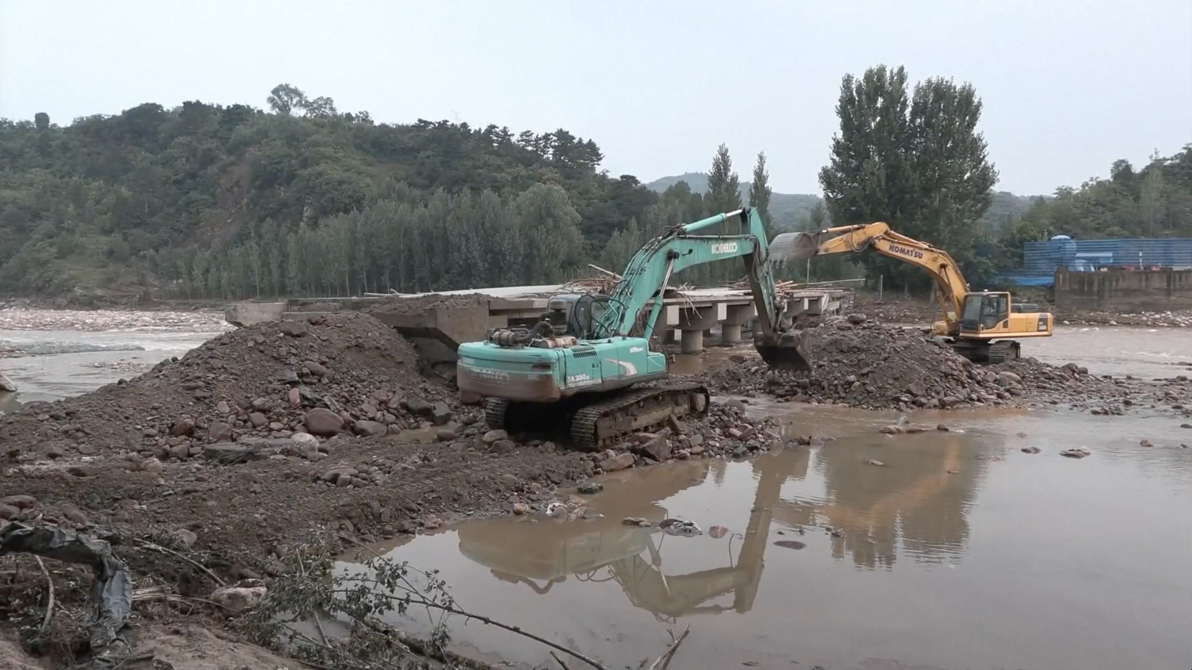 Excavators clean blockage in Huailai County, Zhangjiakou City, Hebei Province, August 9, 2023. /CMG