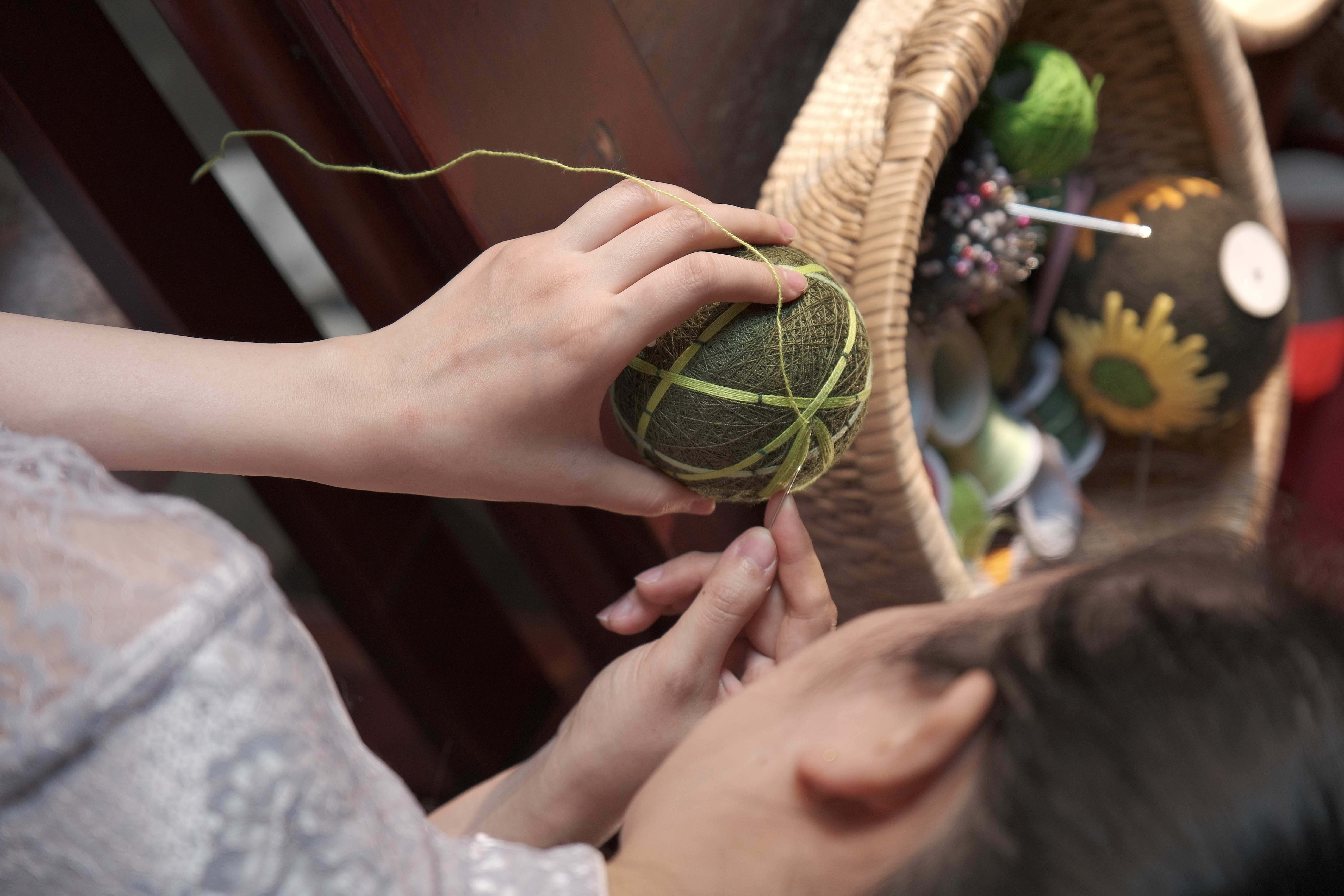 A view of a craftswoman stitching hand-embroidered cuju in Zibo, Shandong Province /CGTN