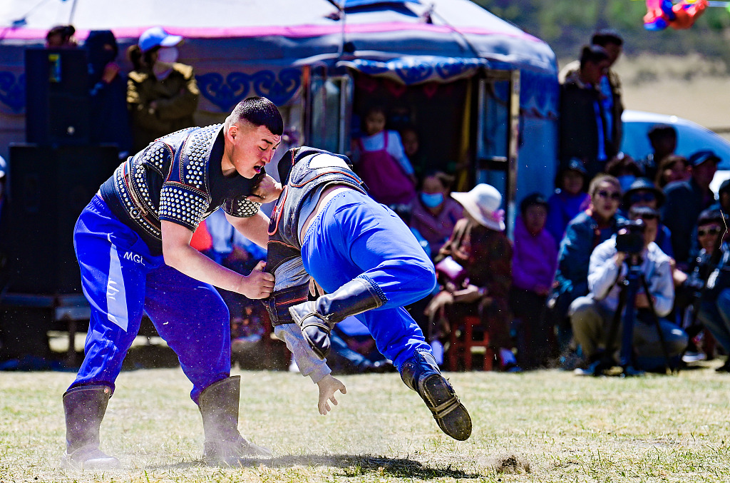 Two men compete in a wrestling match held in Hinggan League, northeast Inner Mongolia. /CFP