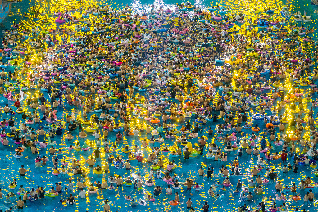 An aerial photo shows people enjoying themselves at a water park in Nanjing, Jiangsu, August 12, 2023. /CFP