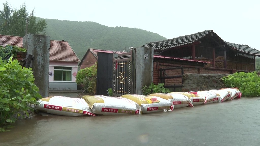 Sandbags piled at the gate of a resident's house in Anshan City of northeast China's Liaoning Province. Heavy rains hit the city on August 12-13, 2023. /CFP
