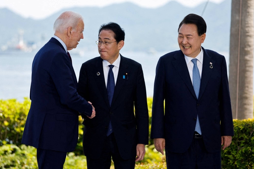 U.S. President Joe Biden (left), Japan's Prime Minister Fumio Kishida (center) and South Korean President Yoon Suk-yeol (right) attend a photo op on the sidelines of the G7 Summit in Hiroshima, Japan, May 21, 2023. /Reuters