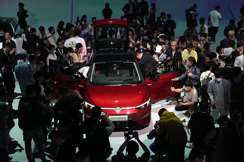 Attendees take a close look at the Volkswagen ID.7 Vizzion, a new electric flagship sedan during a world premiere on the eve of the Shanghai International Automobile Industry Exhibition in east China's Shanghai, April 17, 2023. /CFP