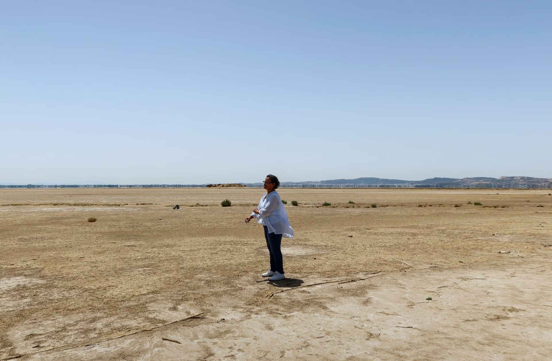 Tunisian environmental activist, Radhia Haddad, stands on the dried-out Ariana lagoon, in Ariana, Tunisia, August 11, 2023. /CFP