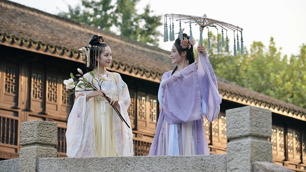 Dressed in hanfu, young Chinese women chat at a cultural center in Huzhou, east China's Zhejiang Province, on August 12, 2023. /CFP