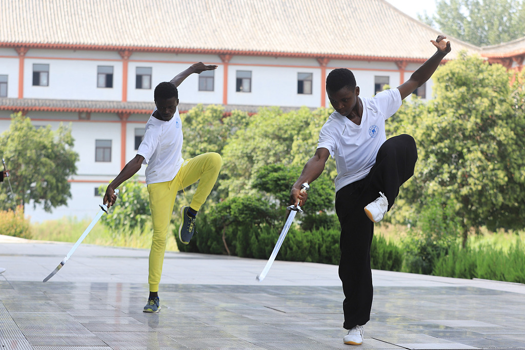 Foreign students practice Taiji single-sword moves at the Chenjiagou Taijiquan Cultural International Exchange Center in Wenxian County, Jiaozuo, Henan Province, on August 14, 2023. /CFP