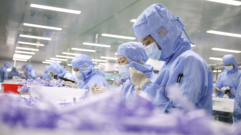 Workers test medical device products at a factory in Hangzhou City, east China's Zhejiang Province, April 25, 2022. /CFP