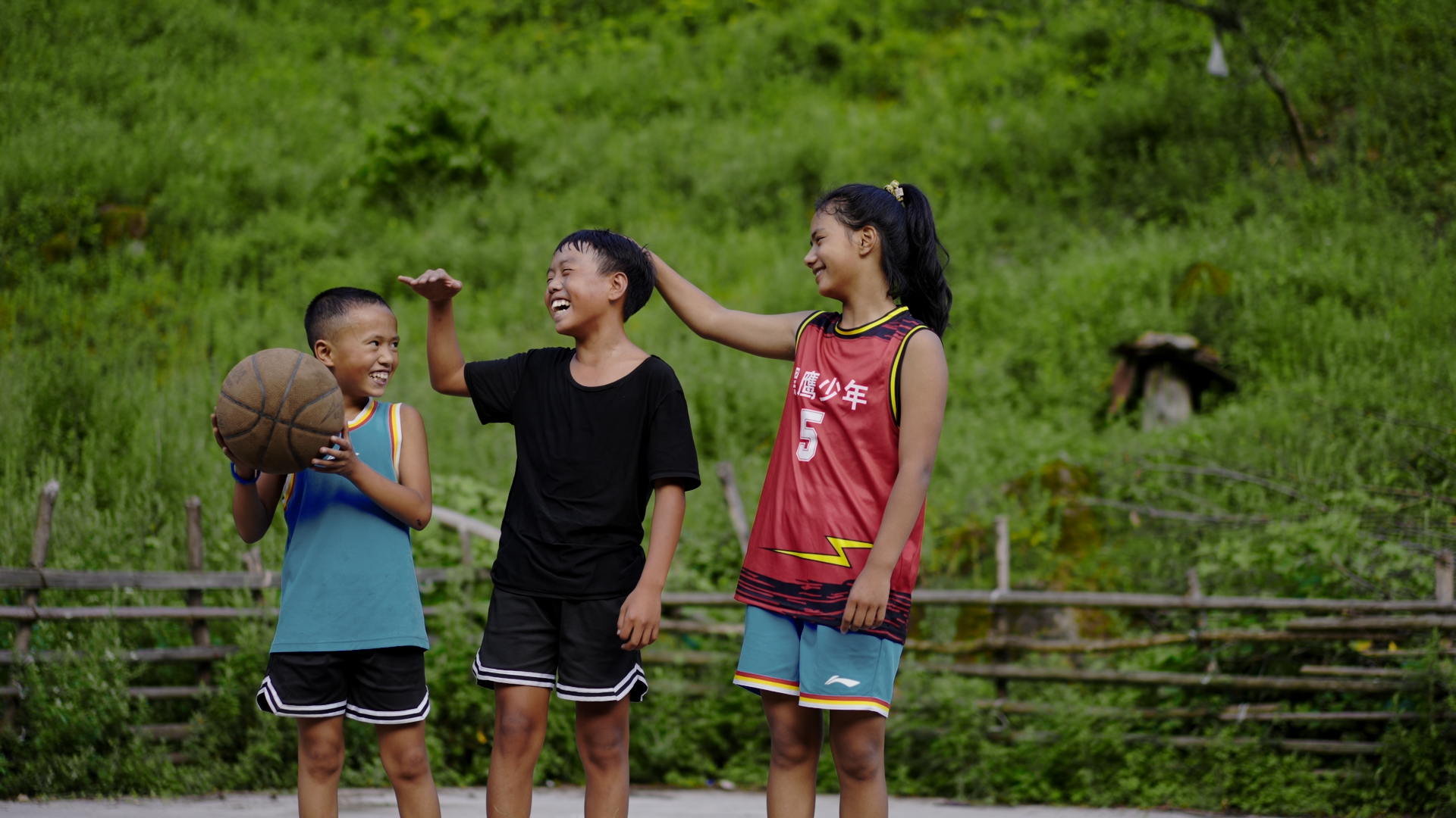 An undated photo shows 13-year-old girl Aguolieha (right) and her teammates in Liangshan Yi Autonomous Prefecture, southwest China's Sichuan Province, after basketball trainings. /CGTN