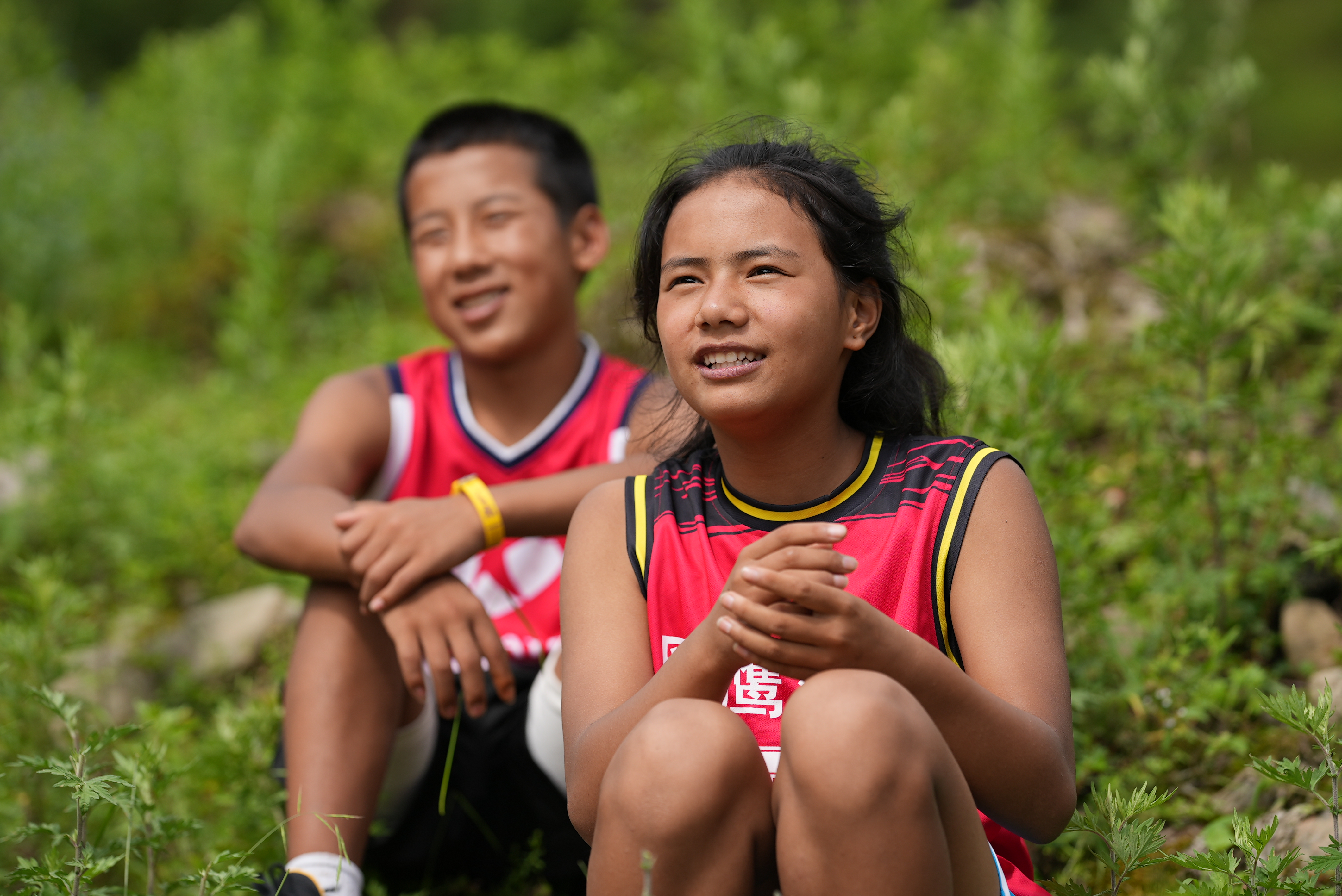 An undated photo shows 13-year-old girl Aguolieha and her teammate in Liangshan Yi Autonomous Prefecture, southwest China's Sichuan Province, after basketball trainings. Playing for a team called the “Blackhawks,” the name comes from the totem of the Yi ethnic group, with the meaning to soar fearlessly. /CGTN